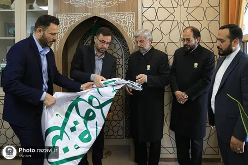 Ghadiriyeh flag of Imam Ali Shrine gifted to Imam Reza Shrine