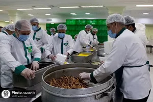 پخت و توزیع غذای متبرک ماهی سفره شب عید در مهمانسرای حضرت