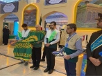 حضور خادمان رضوی با پرچم متبرک حرم مطهر در نمایشگاه بین‌المللی کتاب تهران 
